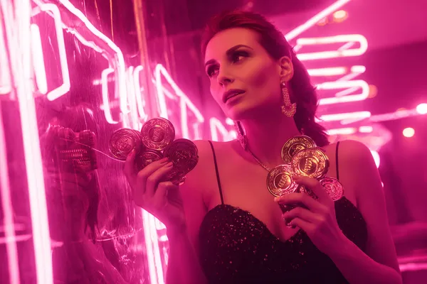A glamorous woman holding casino chips in a neon-lit environment, representing the premium online casino atmosphere of UUOK.